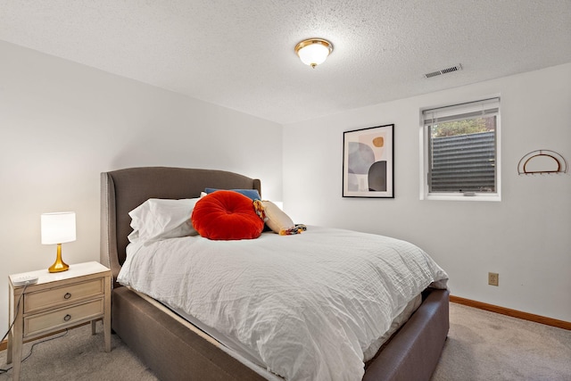 carpeted bedroom with a textured ceiling