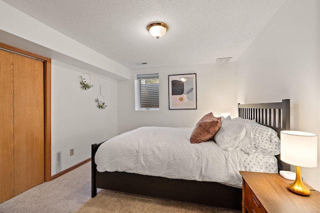 bedroom with carpet, a textured ceiling, and a closet