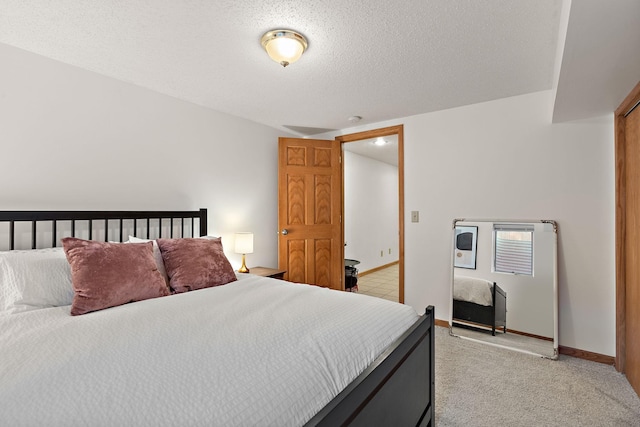 carpeted bedroom featuring a textured ceiling