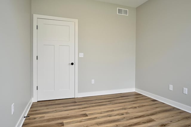 spare room with hardwood / wood-style floors