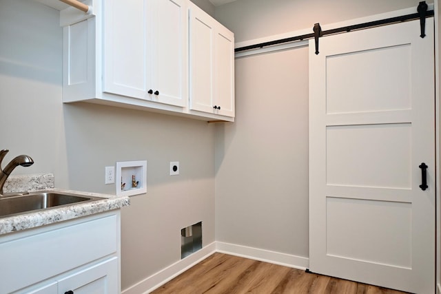 clothes washing area with sink, cabinets, washer hookup, hookup for an electric dryer, and light wood-type flooring