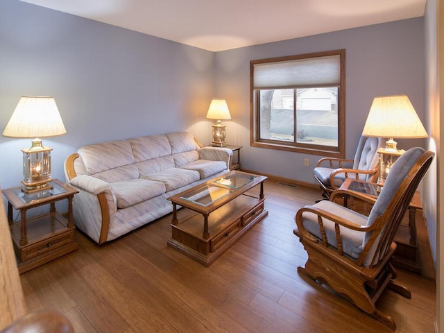 living room with visible vents and wood finished floors