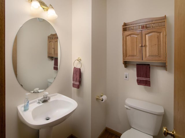 bathroom featuring toilet and a sink