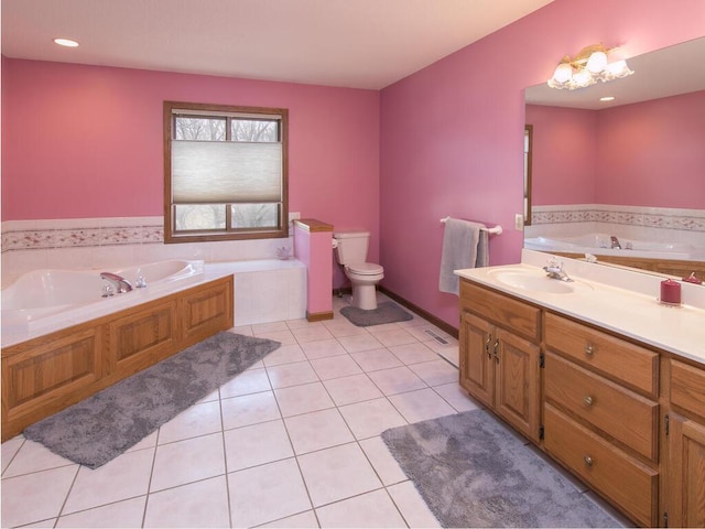 full bathroom featuring a garden tub, vanity, toilet, and tile patterned floors