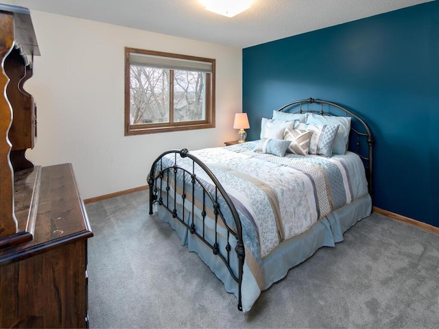 carpeted bedroom featuring baseboards