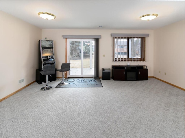 carpeted office featuring baseboards and visible vents