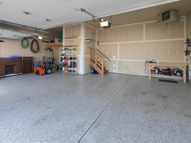 garage featuring a garage door opener and a workshop area