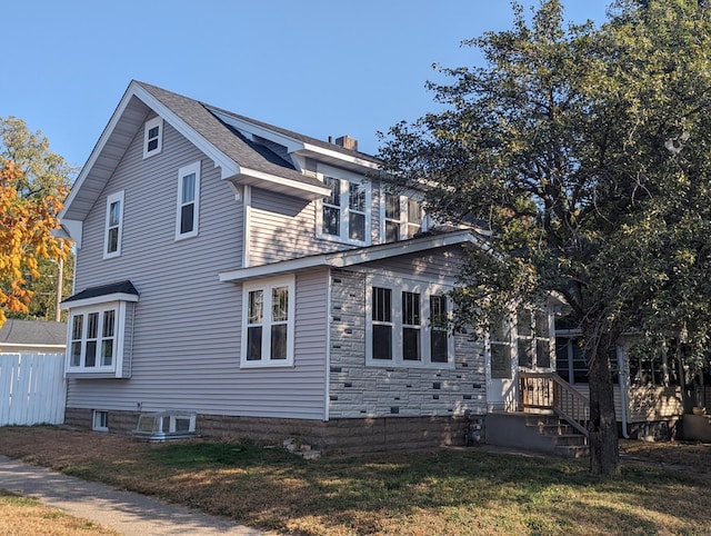 view of side of home featuring a lawn