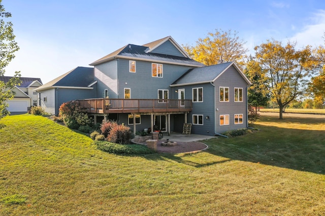 back of house featuring a patio area, a wooden deck, and a lawn