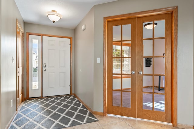 tiled entrance foyer featuring french doors