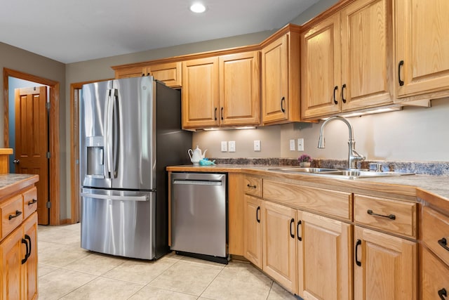 kitchen with sink, stainless steel appliances, and light tile patterned floors