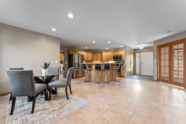 tiled dining area featuring french doors