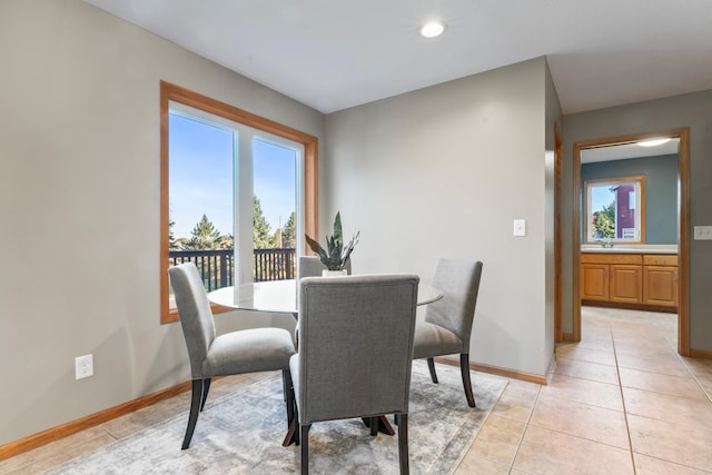 tiled dining space with sink and a healthy amount of sunlight