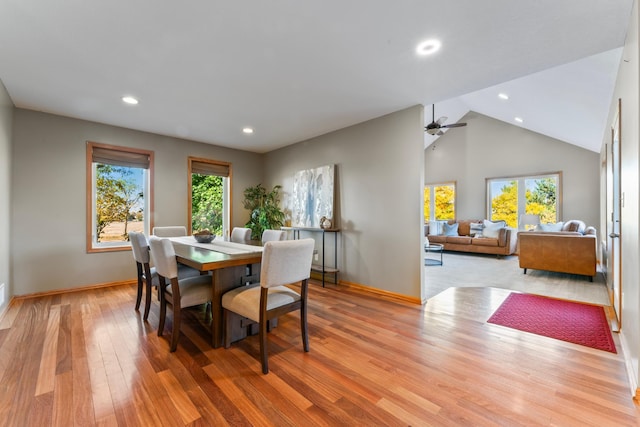 dining area featuring light hardwood / wood-style floors, high vaulted ceiling, a wealth of natural light, and ceiling fan