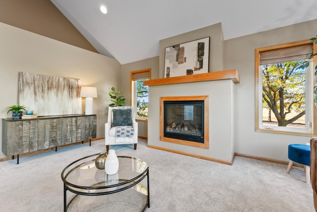 living area with light carpet, vaulted ceiling, and plenty of natural light