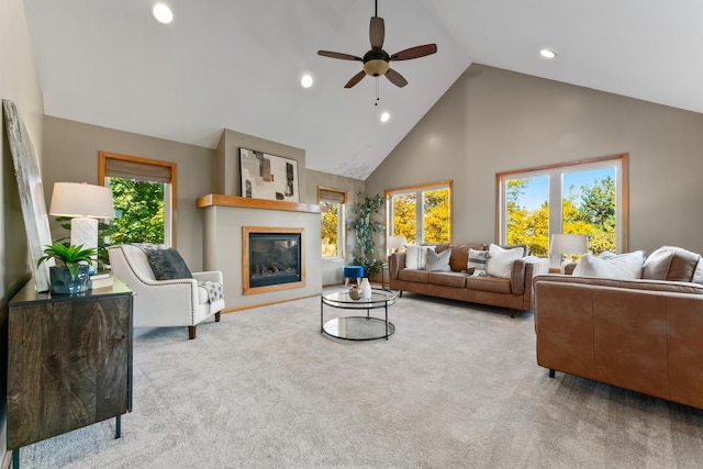 carpeted living room featuring high vaulted ceiling, a healthy amount of sunlight, and ceiling fan