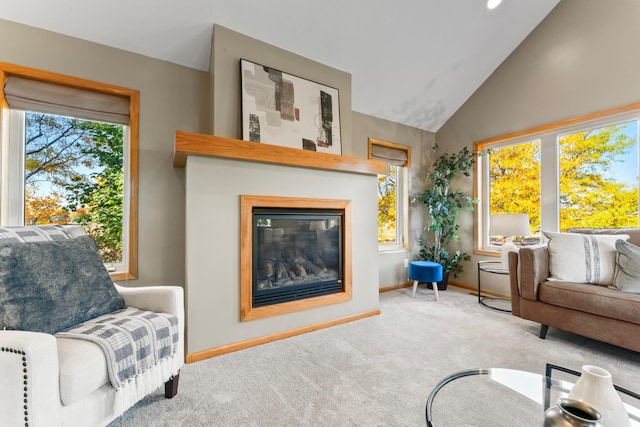 sitting room with light carpet and high vaulted ceiling