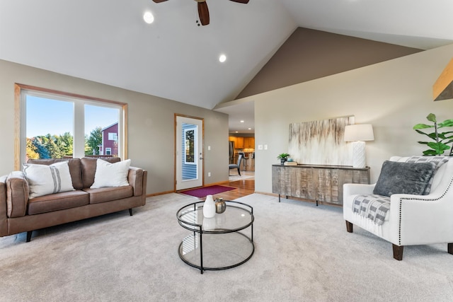 living room featuring light carpet, high vaulted ceiling, and ceiling fan