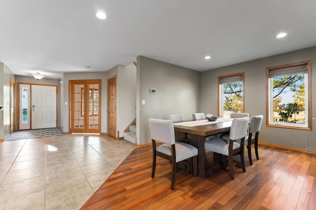 dining area featuring french doors and light hardwood / wood-style floors