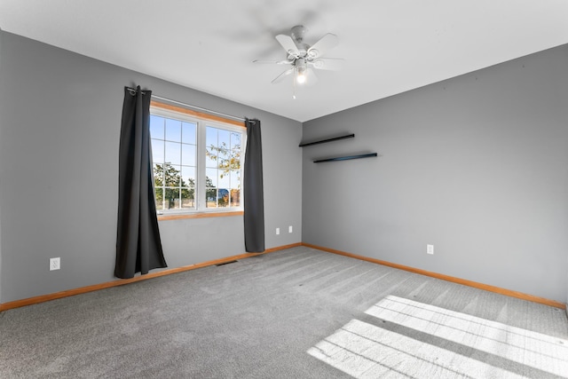 empty room featuring carpet flooring and ceiling fan