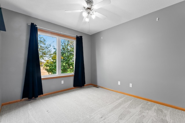 empty room featuring ceiling fan and carpet floors