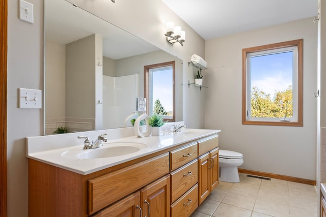 bathroom featuring vanity, toilet, and tile patterned flooring