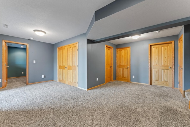 unfurnished bedroom featuring carpet floors and a textured ceiling