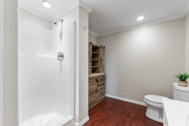 bathroom featuring wood-type flooring, a shower, toilet, vanity, and crown molding