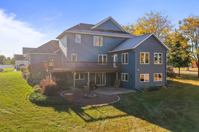 rear view of house with a yard, a patio area, and a deck