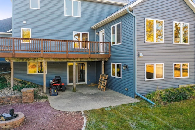 rear view of house with a deck and a patio