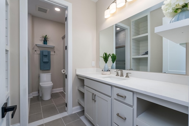 bathroom with tile patterned flooring, vanity, and toilet