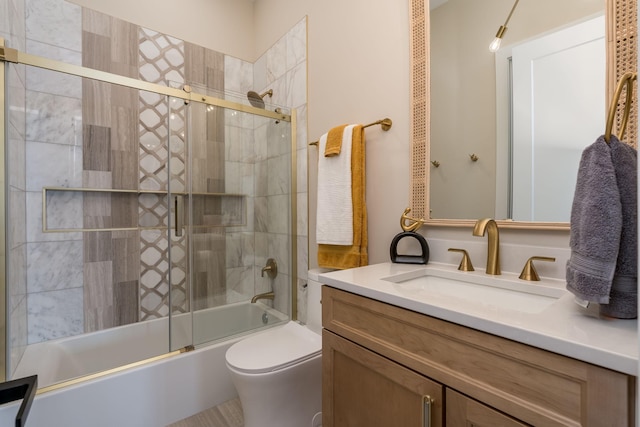 full bathroom featuring vanity, toilet, and combined bath / shower with glass door