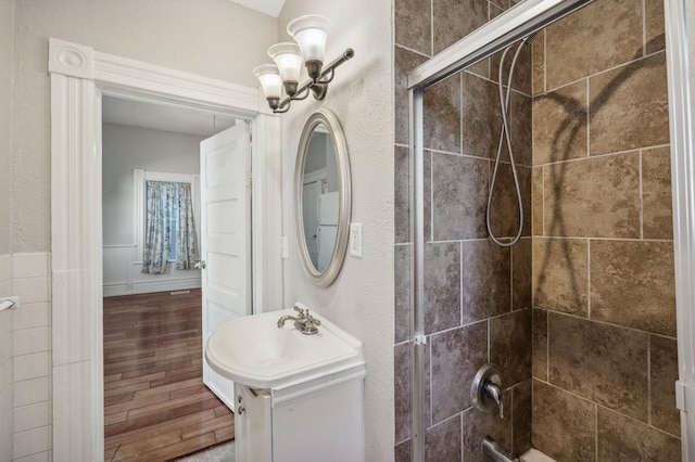 bathroom with vanity, an enclosed shower, and wood-type flooring