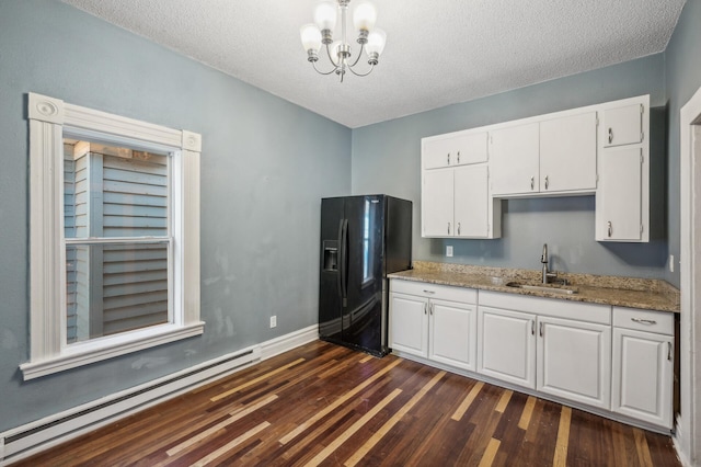 kitchen with sink, black refrigerator with ice dispenser, white cabinetry, dark hardwood / wood-style floors, and a baseboard radiator