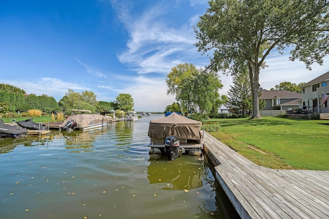 dock area featuring a water view and a lawn