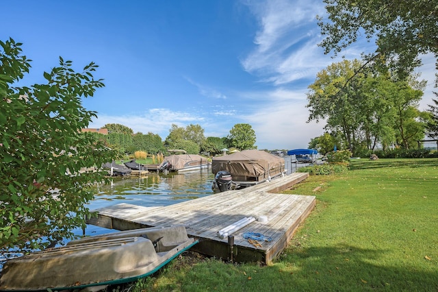 view of dock with a lawn