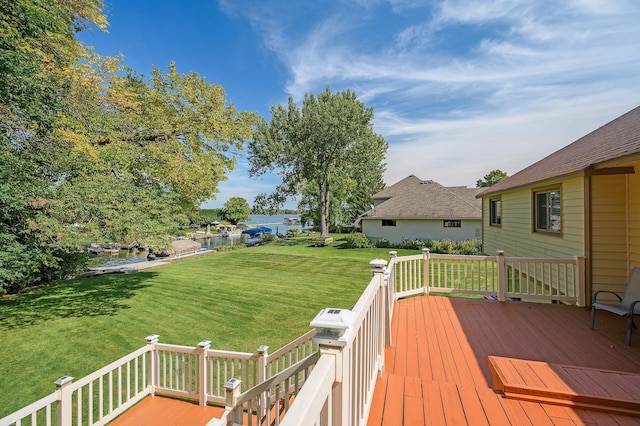 wooden terrace featuring a yard