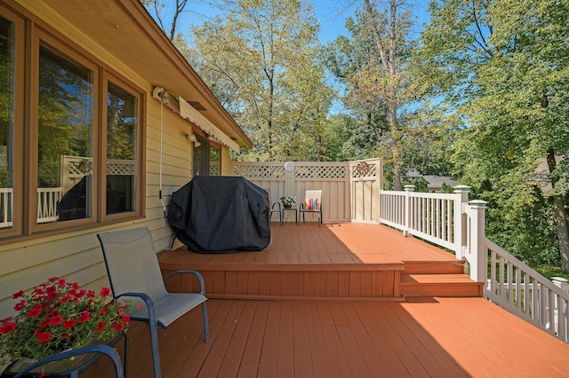 wooden terrace featuring a grill