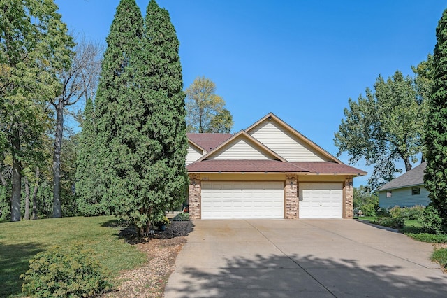 view of front of house featuring brick siding, a garage, concrete driveway, and a front lawn