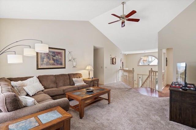 carpeted living area featuring high vaulted ceiling and a ceiling fan