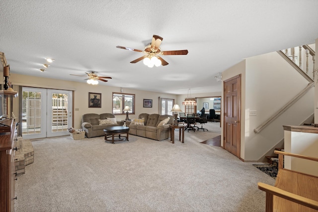 living room featuring stairway, a textured ceiling, and carpet flooring