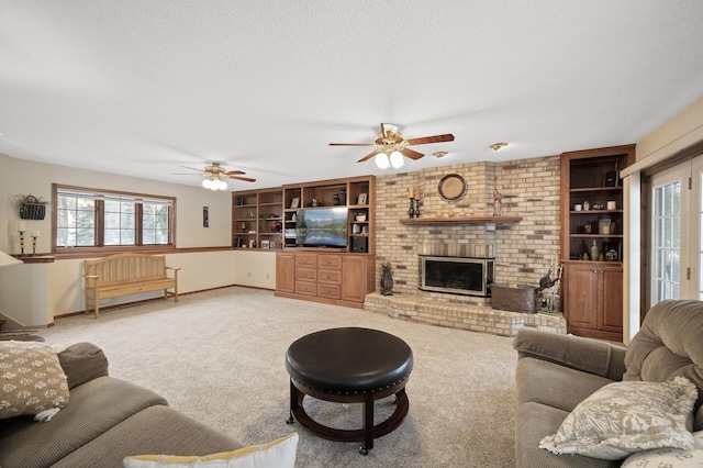 living room with carpet, baseboards, ceiling fan, a textured ceiling, and a brick fireplace