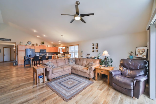 living room featuring lofted ceiling, light hardwood / wood-style floors, and ceiling fan