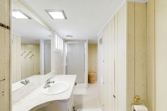 4312 Georgia Ave N, Crystal, MN 55428 - full bathroom with vanity, a stall shower, and wood walls