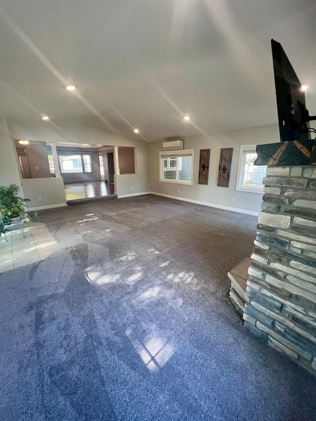 712 11th St, Montevideo, MN 56265 - unfurnished living room featuring carpet floors, a wall mounted air conditioner, baseboards, and recessed lighting
