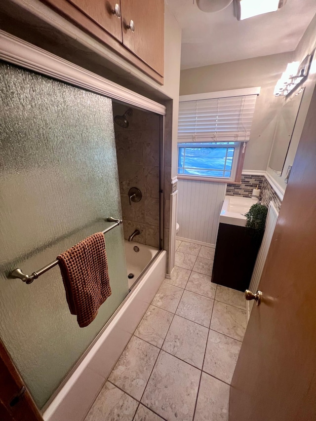 full bathroom featuring shower / bath combination with glass door, vanity, toilet, and tile patterned floors