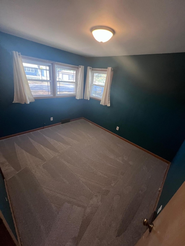 unfurnished room with carpet flooring