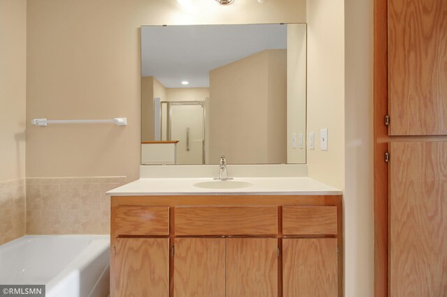 bathroom with vanity and independent shower and bath