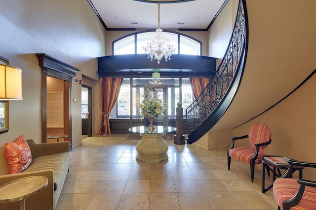 tiled foyer featuring plenty of natural light, a chandelier, and crown molding