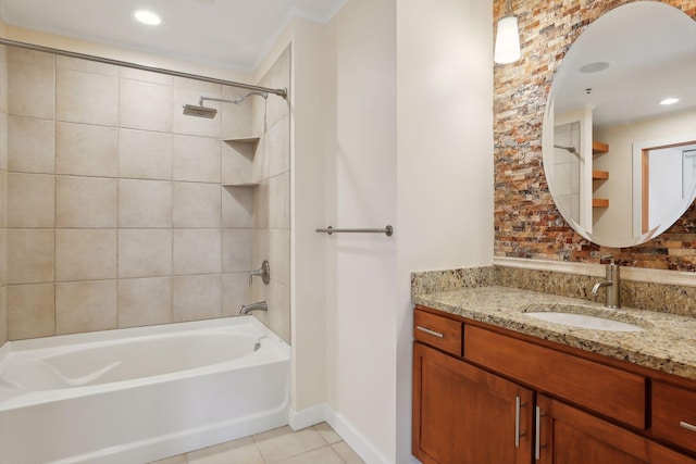 bathroom featuring tile patterned flooring, crown molding, tiled shower / bath combo, and vanity